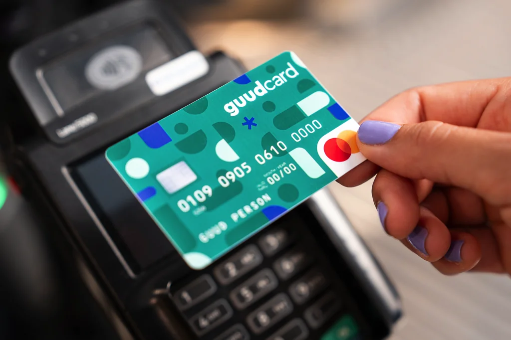 Frau hält Kreditkarte an ein EC Gerät